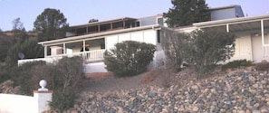 Home on the side of the canyon with covered deck and enclosed patio