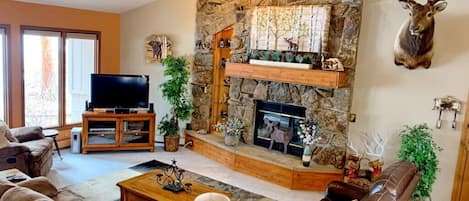 Beautiful Rock fireplace and vaulted ceilings in the open living room area