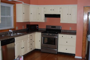 Large kitchen with gas range & full size refrigerator