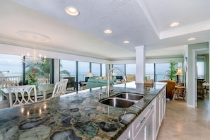 Open kitchen, dining, living with amazing floor to ceiling panoramic ocean view!