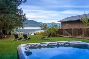 Lovely hot springs tub with lake views. Between the home and lake, the large lawn is perfect for games and countless hours of family fun.