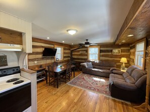 main level has the kitchen and living area with a porch overlooking the woods
