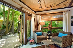 A tropical atmosphere is created with thatched ceiling and cool tile floors.