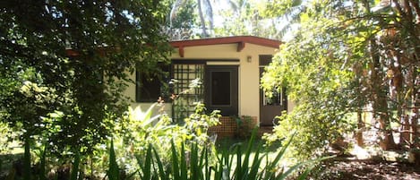 The Honey House is a bungalow in a tropical garden