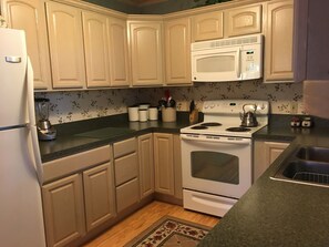 Main level kitchen is fully equipped with dishes, linens, and appliances.