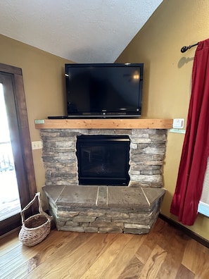 You can watch the TV while relaxing by the gas fireplace.