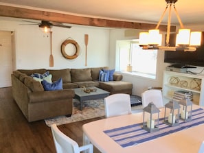 Living room with large sectional and flat screen TV.