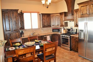 Kitchen with microwave, stove, oven, ice maker, all kitchen utensils.
