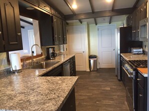 New kitchen, new countertops new sink new floors new range and microwave new lighting