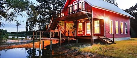 Cabin on pond with pier and upstairs balcony