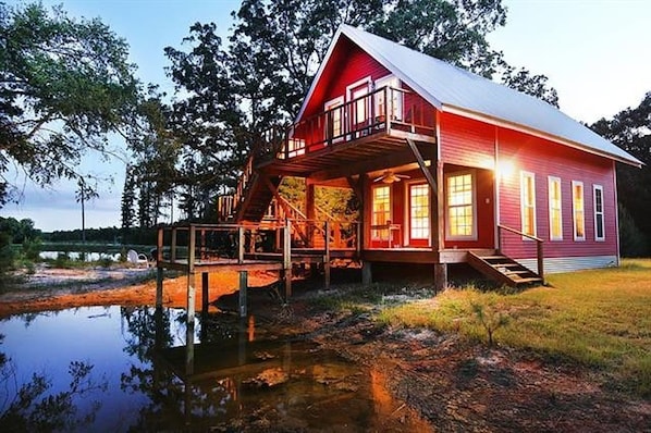 Cabin on pond with pier and upstairs balcony