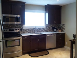 Brand new kitchen with granite and stainless steel appliances