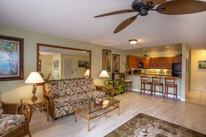 Spacious air-conditioned living room has brand new flooring & a great ocean view