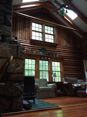 Comfortable seating and a fireplace in the two story space.
