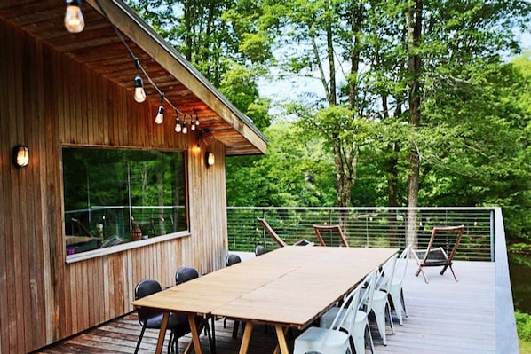The deck overlooks the 5-acres lake. We have a table that seats 8 people.