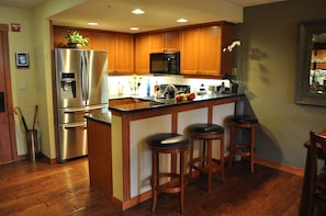 Immaculate, clean, spotless kitchen area with dining bar, stools and wood floors