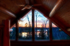 Sunset view from loft couch/reading area after leaves have fallen in fall