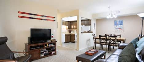 View of living room, dining area and kitchen from front door.