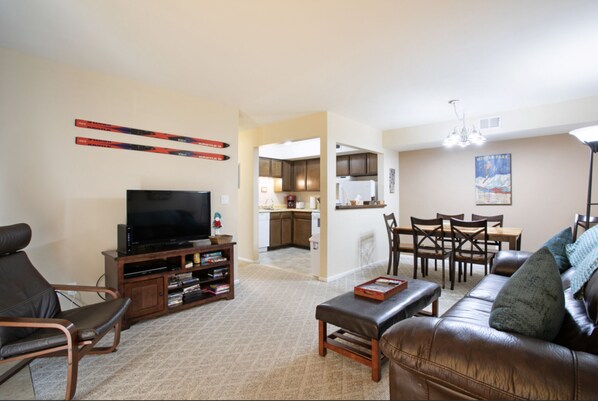 View of living room, dining area and kitchen from front door.