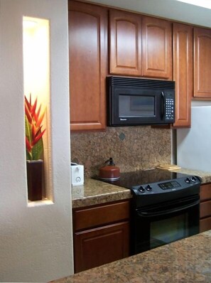 New Kitchen with Granite Counters & designer inlay brass tiles