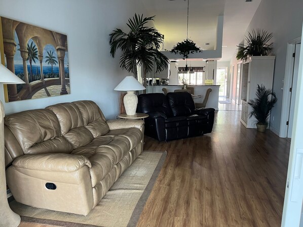 Leather couch and love seat; both recline and face TV and Lanai