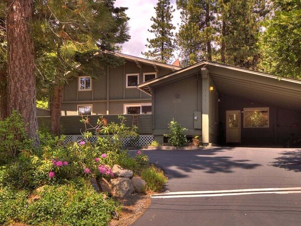 With a two-car carport and a three-car driveway, the front of the house provides ample parking space for multiple vehicles