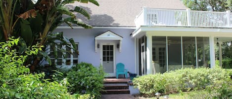 Front view of the home with screened porch, second-floor porch, & sun porch.