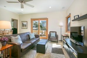 Comfortable living area with TV viewing, ocean view from the window and balcony.