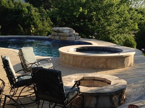 The pool has a shallow beach area with umbrella holder for extra shade
