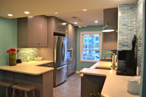 Kitchen with 2 counter bar stools for added seating