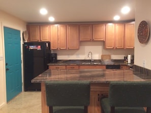 Kitchen with new appliances and breakfast bar