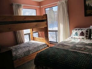 Second bedroom with queen bed and bunk beds, sleeps 4