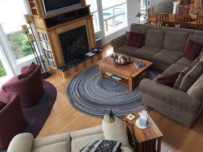 Great room from loft showing gas fireplace and seating