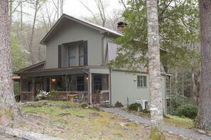 Side view of cabin.  Gravel paths on each side take you down to private seating.