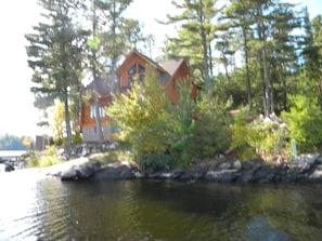 View of log lodge from lake facing west