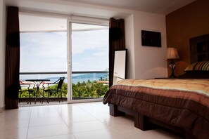 Master bedroom king bed with private balcony.