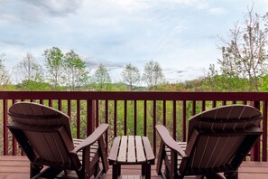 Enjoy the serene wooded view from the back deck
