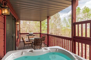 Main level back deck has the hot tub, outdoor dining and gas grill