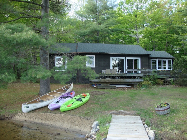 Cottage from dock, southern exposure. Sunny decks. Canoe, kayaks included.