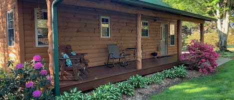 Sheltered front porch featuring comfortable seating for a inviting ambiance.