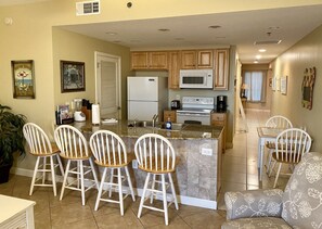  Fully stocked kitchen with granite countertops, breakfast bar and dinette table