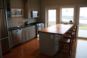 Modern kitchen for gourmet cooking with oceanfront view and gas range