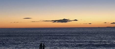 Guests enjoying the sunset on Kepuhi Beach.