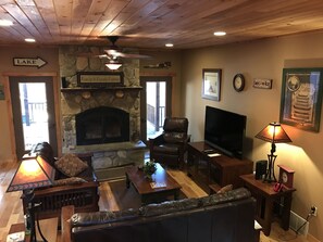 Living area with stone wood burning fireplace