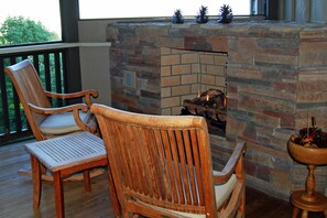 Rock in front of a cozy fire on the screened porch