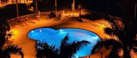 View of the pool at night from the balcony.