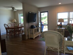 Enter to a view of the pond and of living/dining area with slider to deck.