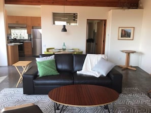 Living room looking toward kitchen dining table and bedroom