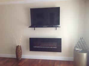 Flatscreen tv and wall mount fireplace in living room