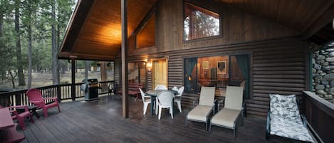 Front of cabin and its relaxing wood covered deck for all year-round BBQ experience.